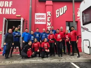 Surf Ireland group outside the red frontage of Ben’s Surf Clinic.